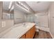 Bathroom features a large mirror, modern vanity, and a shower-tub combination at 9505 Belgate Ct, Las Vegas, NV 89129