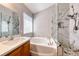 Nicely appointed bathroom featuring a separate soaking tub and walk-in shower at 9505 Belgate Ct, Las Vegas, NV 89129