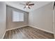 Neutral bedroom with hardwood floors, a ceiling fan, natural light, and a closet at 9505 Belgate Ct, Las Vegas, NV 89129