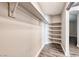 Walk-in closet with wood-look floors and built-in shelving at 9505 Belgate Ct, Las Vegas, NV 89129