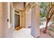Covered front porch featuring a stylish entrance door, textured columns, and well-maintained surroundings at 9505 Belgate Ct, Las Vegas, NV 89129
