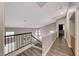 Second story hallway with wood-look floors and view of the stairs at 9505 Belgate Ct, Las Vegas, NV 89129