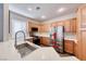 Well-equipped kitchen with stainless steel appliances, light countertops, and ample wood cabinet space at 9505 Belgate Ct, Las Vegas, NV 89129