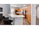 Modern kitchen with breakfast bar, stainless steel appliances, wood cabinets and sleek black bar stools at 9505 Belgate Ct, Las Vegas, NV 89129