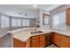 Bright kitchen with white quartz countertops, wood cabinets, stainless steel appliances, and a modern sink at 9505 Belgate Ct, Las Vegas, NV 89129