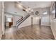 Spacious living room with wood-look floors, a staircase, and an open layout flowing into the kitchen at 9505 Belgate Ct, Las Vegas, NV 89129