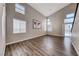 Open living area with soaring ceilings, wood-look floors, and ample natural light from multiple windows at 9505 Belgate Ct, Las Vegas, NV 89129