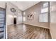 Bright living area featuring wood-look flooring, high ceilings, and a staircase leading to the upper level at 9505 Belgate Ct, Las Vegas, NV 89129