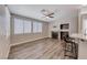 Inviting living room featuring a fireplace, hardwood floors, ceiling fan, and lots of natural light at 9505 Belgate Ct, Las Vegas, NV 89129