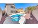 Backyard features a pool and spa, desert landscaping, mature palm trees, and exterior elevation at 9505 Belgate Ct, Las Vegas, NV 89129