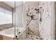 Close-up view of walk-in shower with marble-look tile at 9505 Belgate Ct, Las Vegas, NV 89129