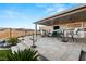 Outdoor living space featuring a covered patio with a built-in grill and bar area with mountain views at 984 Edinburgh Fields Ct, Las Vegas, NV 89138