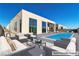 Stunning backyard with a modern pool and stylish outdoor furniture at 10739 Agate Cliffs Ave, Las Vegas, NV 89135