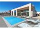 Stunning backyard with a modern pool and lounge chairs at 10739 Agate Cliffs Ave, Las Vegas, NV 89135