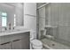 Modern bathroom featuring walk-in glass shower with neutral tile, vanity, and marble countertop at 10739 Agate Cliffs Ave, Las Vegas, NV 89135