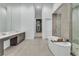 Large bathroom featuring a soaking tub, walk-in shower, double vanity and tile flooring at 10739 Agate Cliffs Ave, Las Vegas, NV 89135