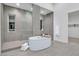Bathroom with an oval tub, walk-in shower, and access to a closet at 10739 Agate Cliffs Ave, Las Vegas, NV 89135