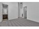 Bright bedroom featuring plush carpet, neutral walls, a ceiling vent, and two open doorway entryways at 10739 Agate Cliffs Ave, Las Vegas, NV 89135