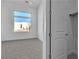 Bright bedroom featuring plush carpet, neutral walls, large window, and a bedroom closet at 10739 Agate Cliffs Ave, Las Vegas, NV 89135