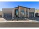 Contemporary home with stone landscaping, a modern architectural design, and a two-car garage under a blue sky at 10739 Agate Cliffs Ave, Las Vegas, NV 89135