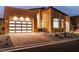 Contemporary home exterior featuring a stylish garage with translucent doors, modern landscaping, and a brick driveway at 10739 Agate Cliffs Ave, Las Vegas, NV 89135