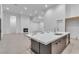 Open concept, spacious kitchen with island seating, and stainless steel appliances at 10739 Agate Cliffs Ave, Las Vegas, NV 89135