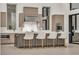 Modern kitchen with stainless steel appliances, island with seating, and ample cabinet space at 10739 Agate Cliffs Ave, Las Vegas, NV 89135