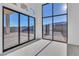 Bright living room with large sliding glass doors to patio, carpet flooring, and plenty of natural light at 10739 Agate Cliffs Ave, Las Vegas, NV 89135