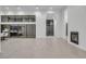 Spacious living room featuring contemporary design, sleek fireplace, and large windows at 10739 Agate Cliffs Ave, Las Vegas, NV 89135
