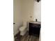 This powder room features a granite countertop and modern fixtures at 10799 Flame Vine Ct, Las Vegas, NV 89135