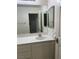 A bathroom sink with a large mirror and a smaller mirror on the side at 10799 Flame Vine Ct, Las Vegas, NV 89135