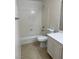 This bathroom features a shower-tub combo and a white toilet and vanity at 10799 Flame Vine Ct, Las Vegas, NV 89135