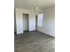 A bedroom features wood-look floors, closet, and a chandelier at 10799 Flame Vine Ct, Las Vegas, NV 89135