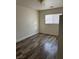 This bedroom has wood-look flooring, light-colored walls, and a window for natural light at 10799 Flame Vine Ct, Las Vegas, NV 89135