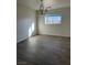 A bedroom with wood-look floors and an ornate hanging light fixture at 10799 Flame Vine Ct, Las Vegas, NV 89135