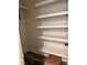 The walk-in closet has built-in shelving on the walls and wood-look floors at 10799 Flame Vine Ct, Las Vegas, NV 89135