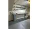 Spacious garage area includes shelving and a convenient work bench at 10799 Flame Vine Ct, Las Vegas, NV 89135