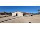 Wide backyard featuring dirt, a sliding glass door, pergola, and exterior walls at 1301 Madison Ave, Las Vegas, NV 89106