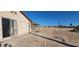 Wide backyard featuring dirt, a sliding glass door and exterior walls at 1301 Madison Ave, Las Vegas, NV 89106