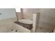 Bathroom featuring a bathtub with marble accents and tiled walls and floors, offering a luxurious retreat at 1301 Madison Ave, Las Vegas, NV 89106
