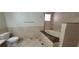 Bathroom featuring a tub, toilet, and tiled walls and floors, showcasing a functional space at 1301 Madison Ave, Las Vegas, NV 89106