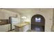 The kitchen has white appliances, granite counters, breakfast bar, and a seamless flow into the dining space at 1301 Madison Ave, Las Vegas, NV 89106
