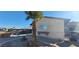 Tan single-story home featuring a front yard palm tree and desert landscaping at 1301 Madison Ave, Las Vegas, NV 89106