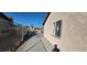 Side yard featuring a secure fence and a view of the home's exterior at 1301 Madison Ave, Las Vegas, NV 89106