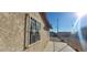Side view of home showcasing secure gated access, stucco and window details at 1301 Madison Ave, Las Vegas, NV 89106
