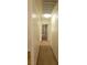 Well-lit hallway with carpet and doors, leading to various rooms in the home at 1325 Fiesta Grande Ct, North Las Vegas, NV 89031