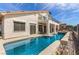 Backyard view showcasing a pool, covered patio, and outdoor dining area, perfect for outdoor entertaining at 1339 Echo Creek St, Henderson, NV 89052