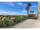 Enjoy panoramic views from this balcony, showcasing palm trees, neighboring houses, and a mountain range in the distance at 1339 Echo Creek St, Henderson, NV 89052