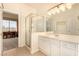 Bathroom with a glass-enclosed shower and white cabinets at 1339 Echo Creek St, Henderson, NV 89052
