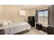 Well-lit bedroom featuring carpet, a checkered curtain, and dark colored furniture at 1339 Echo Creek St, Henderson, NV 89052